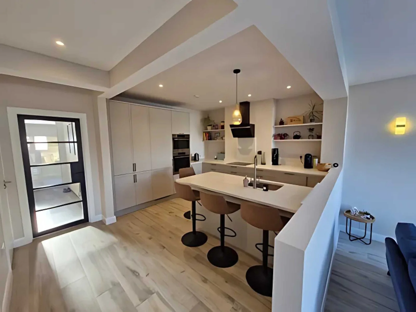 Raised kitchen overlooking the lower lounge in the split-level extension